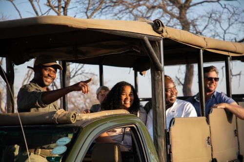 a group of people riding in a golf cart at Unembeza Boutique Lodge & Spa in Hoedspruit