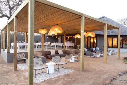 a pavilion with chairs and tables and chandeliers at Unembeza Boutique Lodge & Spa in Hoedspruit