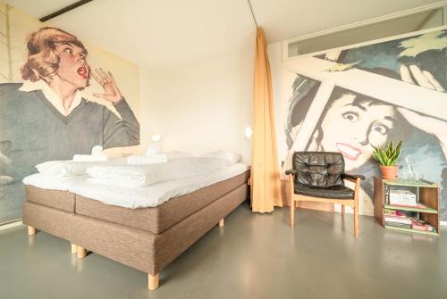 a bedroom with a bed and a painting of a man at Pink Flamingo Boutique Hostel in The Hague