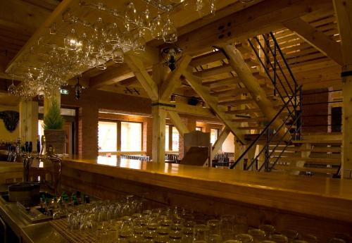 a bar in a room with wine glasses at Domčeky na Ranči in Sučany