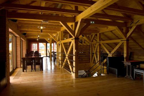 a room with a table and chairs in a barn at Domčeky na Ranči in Sučany