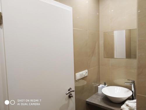 a bathroom with a sink and a mirror at Penzion Relax Martina in České Budějovice