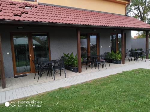 a group of tables and chairs outside of a building at Penzion Relax Martina in České Budějovice