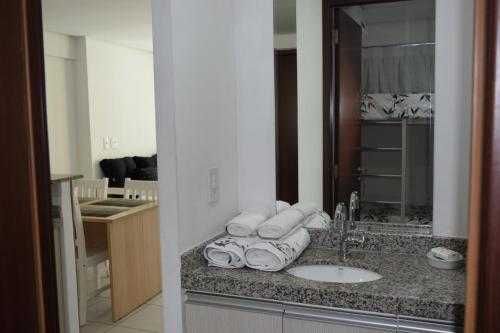 a bathroom counter with a sink and a mirror at Grupo Vip Beach Class Fortaleza in Fortaleza