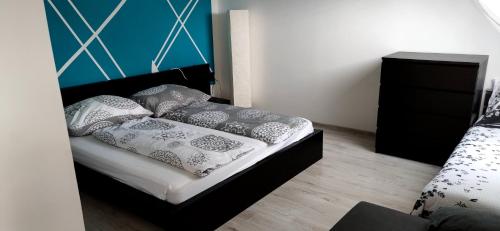 a bedroom with a bed with black and white pillows at Homestay Kuchařovice in Kuchařovice