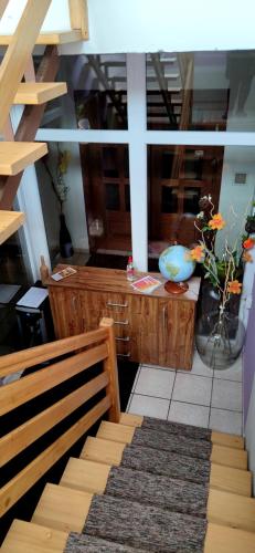 a room with a bench and a desk with a vase of flowers at Homestay Kuchařovice in Kuchařovice