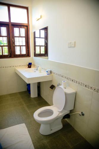 a bathroom with a toilet and a sink at Freedom Lodge, Kandy in Kandy