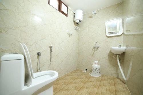 a bathroom with a toilet and a sink at Royal Home Stay deluxe Room in Tirupati