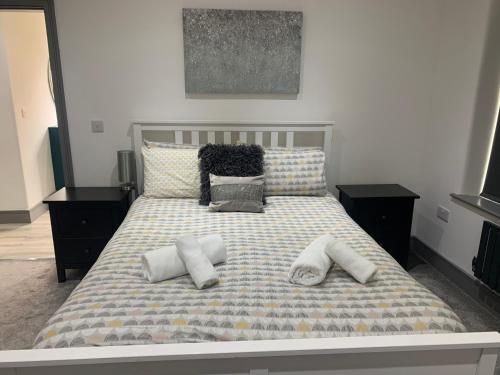 a bedroom with a bed with pillows on it at Lovely 3-Bed House in Lytham Saint Annes in Saint Annes on the Sea