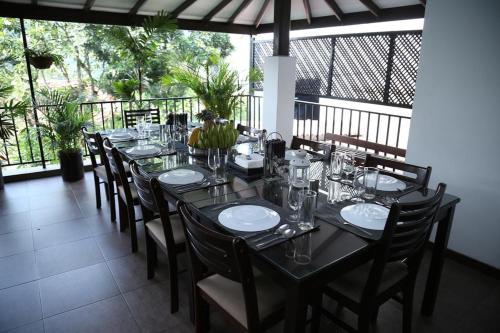 a dining room with a long table and chairs at Freedom Lodge, Kandy in Kandy
