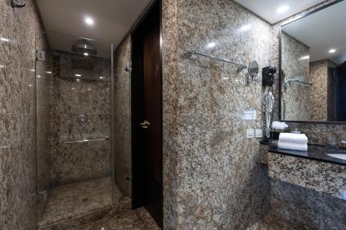 a bathroom with a shower and a sink at Eurobuilding Hotel & Suites Caracas in Caracas