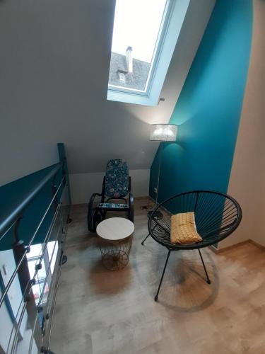 a room with a skylight and a table and chairs at gite de La Carrière in Saint-Julien-de-Piganiol