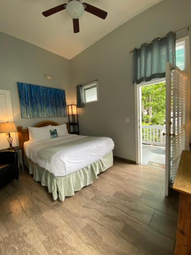 um quarto com uma cama e uma ventoinha de tecto em Douglas House em Key West