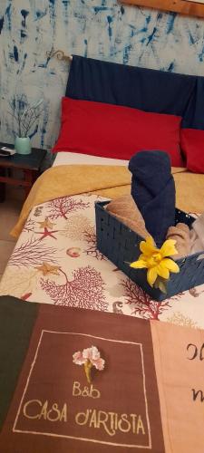 a bed with a sign on top of it at Casa d' Artista B&B in Ozieri