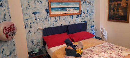 a small bedroom with a bed with red pillows at Casa d' Artista B&B in Ozieri