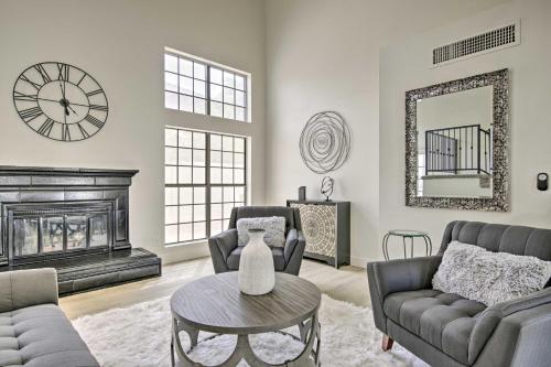 a living room with a fireplace and a clock on the wall at 8 mi to Westgate Family-Friendly Glendale Home! in Glendale