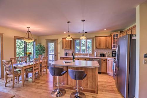 a kitchen with a table and chairs and a refrigerator at Finger Lakes Home with Private Pool and Lake Views! in Hammondsport