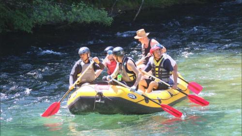 a group of people in a raft on a river at Paulinio in Jajce