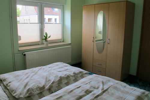 a bedroom with a bed and a dresser and window at Thiesen in Kochendorf