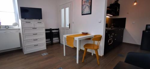 a small kitchen with a desk and a television at Apartmán Augustin Jičín in Jičín