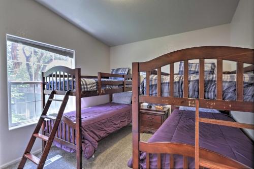 a bedroom with two bunk beds and a window at Rustic Retreat Moab Townhome with Grill and Fire Pit! in Moab