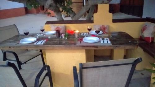 a table with plates and glasses of wine on it at Cuevas Uropia in Graena