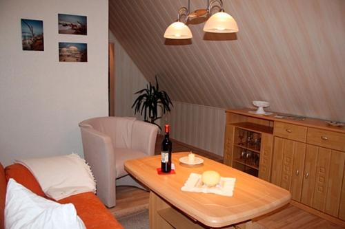 a room with a table with a bottle of wine at Voß, FW in Zingst