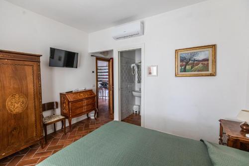 Ένα ή περισσότερα κρεβάτια σε δωμάτιο στο La Locanda di Adele - Il Giardinetto B&B