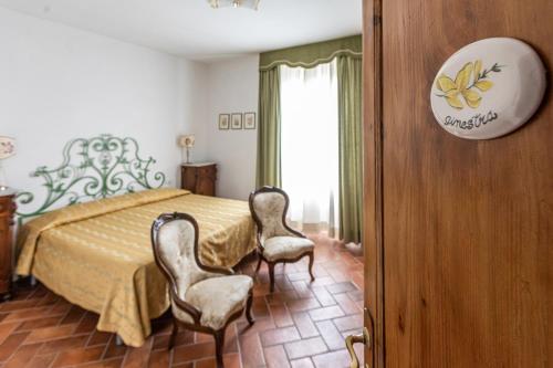 Ένα ή περισσότερα κρεβάτια σε δωμάτιο στο La Locanda di Adele - Il Giardinetto B&B