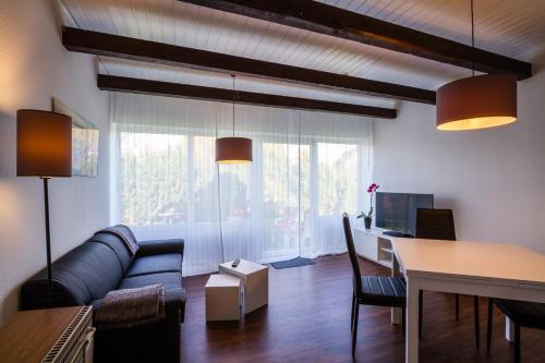 ein Wohnzimmer mit einem Sofa und einem Tisch in der Unterkunft Kleines Sommerhaus Schröder - Im Winkel 1b in Dahme
