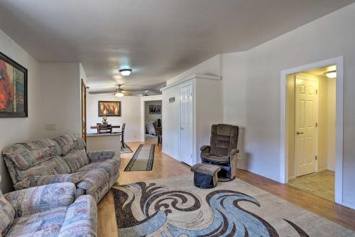 a living room with a couch and a chair at Red Rock Rambler Moab Home with Hot Tub and Views! in Moab