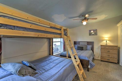 a bedroom with two bunk beds and a ladder at Red Rock Rambler Moab Home with Hot Tub and Views! in Moab