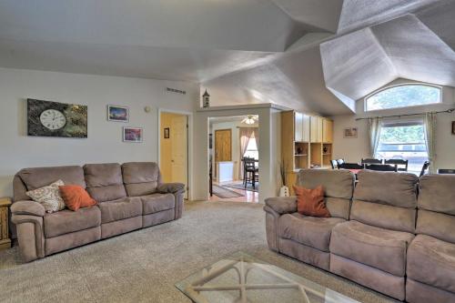 a living room with two couches and a dining room at Red Rock Rambler Moab Home with Hot Tub and Views! in Moab