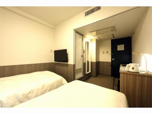 En eller flere senger på et rom på Sendai Business Hotel Ekimae - Vacation STAY 71942v