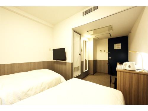仙台市にあるSendai Business Hotel Ekimae - Vacation STAY 71920vのベッド2台とテレビがあるホテルの部屋