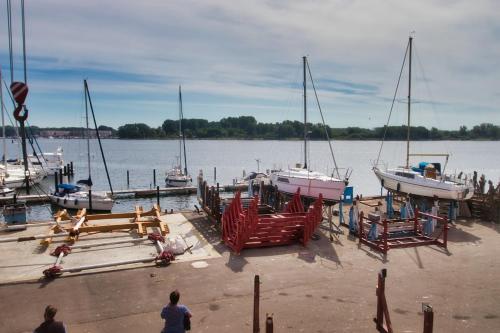 a dock with boats in a body of water at Segellast 4 in Lübeck