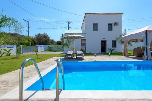 a villa with a swimming pool and a house at Villa Costa in Ixia