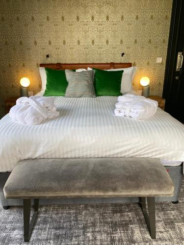 a large bed with two towels on top of it at The Waterman's Arms in London