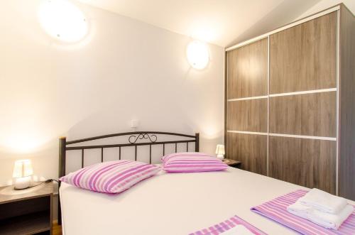 a bedroom with a bed with two pillows on it at Villa Lidija in Omiš