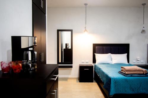 a bedroom with a bed with a blue bedspread at Hotel Casa Tortuga Tulum - Cenotes Park Inclusive in Tulum