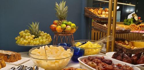a table topped with bowls of fruit and other food at Grand Hotel Regina Salsomaggiore in Salsomaggiore Terme