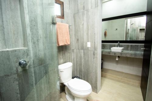 a bathroom with a toilet and a sink at Hotel Casa Tortuga Tulum - Cenotes Park Inclusive in Tulum