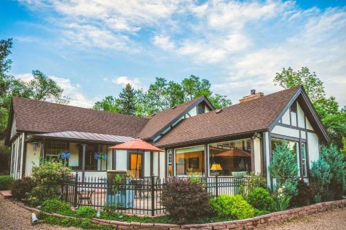 a white house with a brown roof at Spacious Manitou Home with Views in Central Location in Manitou Springs