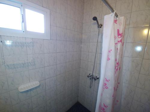 a bathroom with a shower with a shower curtain at Ankara 3 in Las Grutas