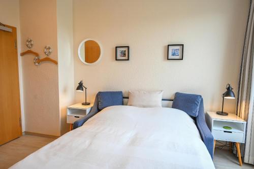 a bedroom with a bed and two tables and two lamps at Zur schönen Aussicht - FW 4 in Dahme