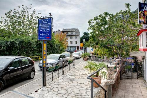 a blue sign on a pole next to a street at Villa Botticelli in Mostar
