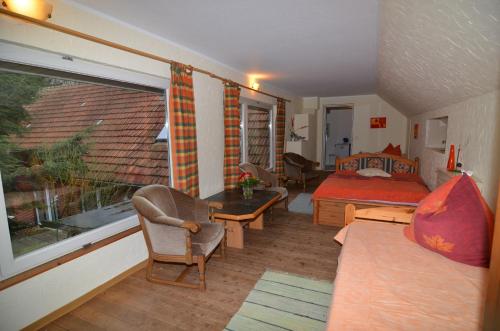 a small bedroom with a bed and a window at Ferienhof Frohne - Kornspeicher in Merzen