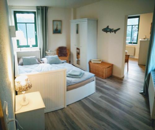 a bedroom with a bed and a table with a lamp at Ferienhaus Bettina in Stolberg