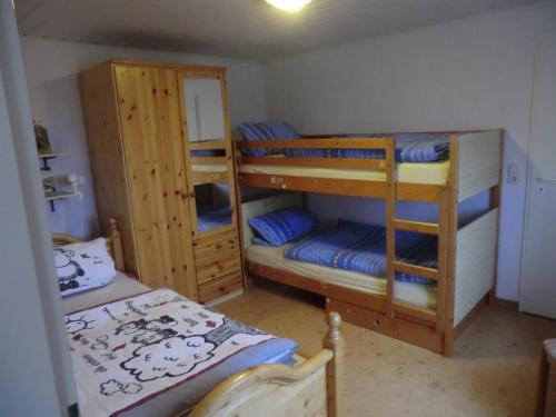 a room with two bunk beds and a bed at Mirscheiderhof in Weidenbach