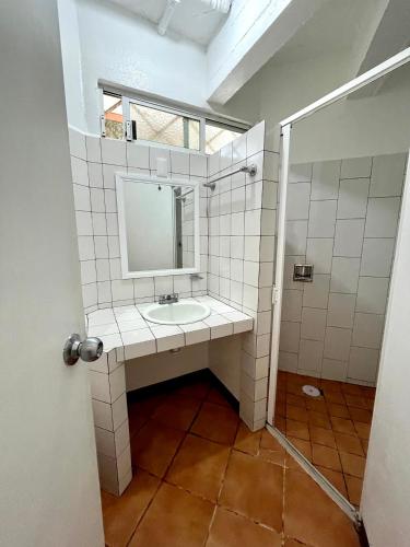 a bathroom with a sink and a mirror at HOTEL BUGAMBILIAS in Oaxaca City